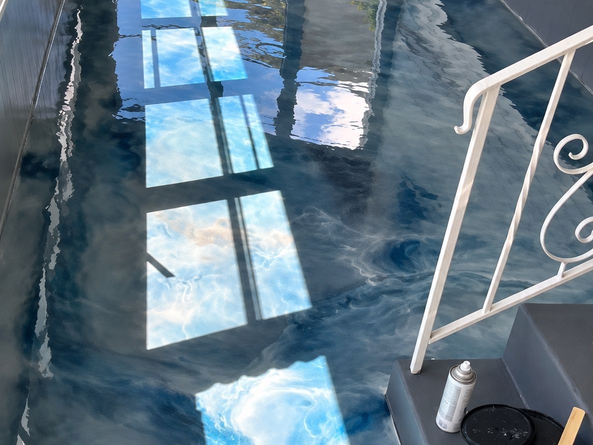 Long enclosed porch floor in high-gloss metallic epoxy swirled blue, white and gray