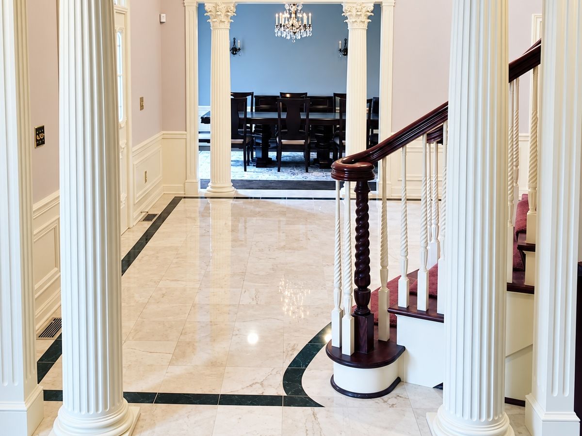 Front hall framed by two cream fluted Corinthian columns