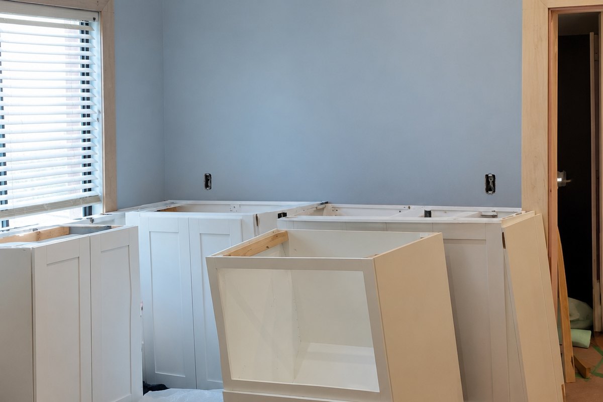 Kitchen remodel with white shaker base cabinet boxes delivered and waiting to be installed